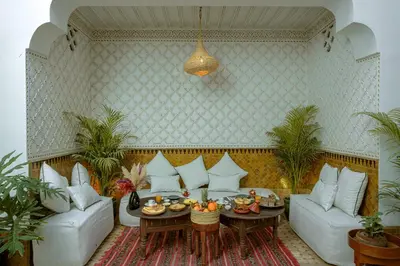 a living room with a couch and a table with food on it at Riad Darino Marrakech Heritage in Marrakech
