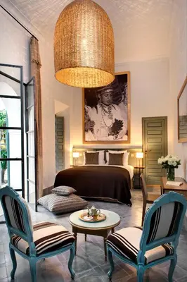 a living room with a bed and a table and chairs at Riad Antara in Marrakech
