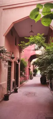 an empty alley with an archway in a building at Riad Naim in Marrakech
