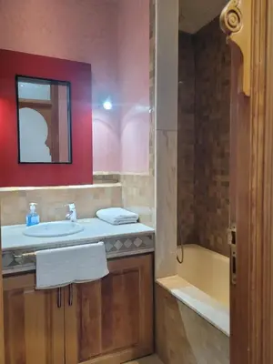 a bathroom with a sink and a bath tub at Palmeraie village 2 , les jardins de la palmeraie 2 in Marrakech