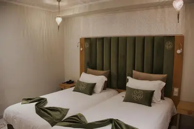 two beds sitting next to each other in a bedroom at Diwane Hotel & Spa Marrakech in Marrakech