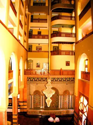 a large room with a fireplace in a building at Diwane Hotel & Spa Marrakech in Marrakech