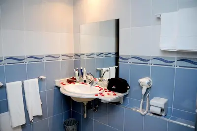 a bathroom with a sink and a mirror at Residence Hotel Assounfou in Marrakech