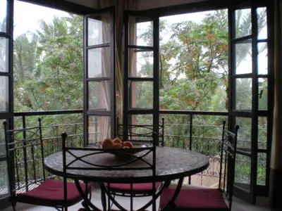 a table with a bowl of fruit on a balcony at Appart avec vue Jardin/Majorelle in Marrakech
