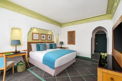 a bedroom with a large bed and a television at Jaal Riad Resort Adults Only in Marrakech