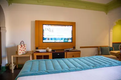 a bedroom with a large bed and a television at Jaal Riad Resort Adults Only in Marrakech
