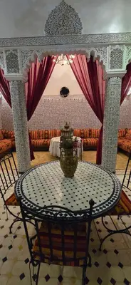 a table with a vase on it in a room at Riad Raffaa in Marrakech