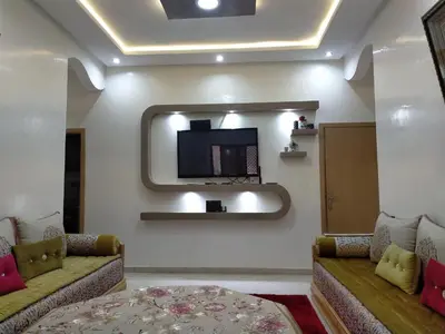 a living room with two couches and a tv at Theresa apartments in Marrakech