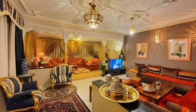 a living room filled with furniture and a tv at Oranger Family House Marrakech City Center in Marrakech