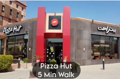 a pizza hut min walk sign in front of a building at Oranger Family House Marrakech City Center in Marrakech