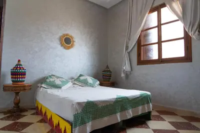 a bedroom with a bed and a window at Riad SARSAR airport in Marrakech
