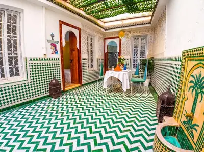 a room with a table and a room with a room at Dar Sarsar Artistic Music in Marrakech