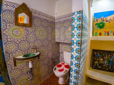 a bathroom with a sink and a toilet in it at Dar Sarsar Artistic Music in Marrakech