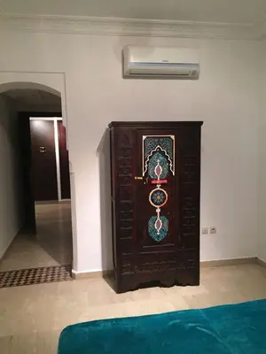 a wooden clock in the corner of a room at Appartement Maria in Marrakech