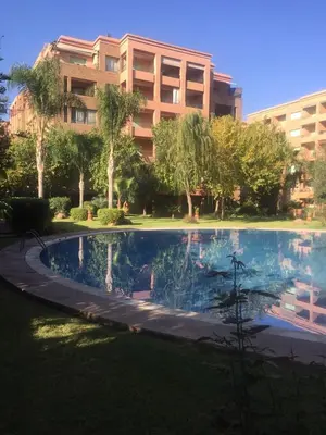 a large swimming pool in front of a building at Appartement Maria in Marrakech