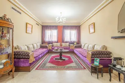 a living room with a purple couch and a table at Majorelle family residence in Marrakech