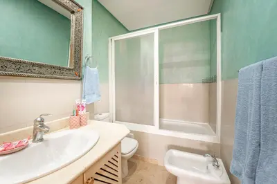 a bathroom with a sink and a toilet and a mirror at Majorelle family residence in Marrakech