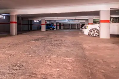 a parking garage with two cars parked in it at Majorelle family residence in Marrakech