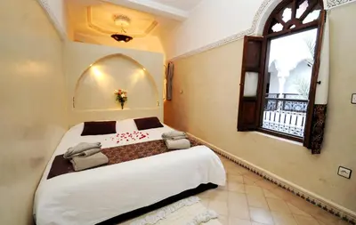 a bedroom with a large bed and a window at Riad Elias & Spa in Marrakech