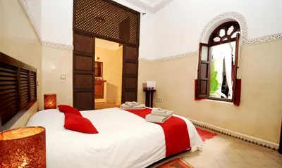 a bedroom with a large white bed and a window at Riad Elias & Spa in Marrakech
