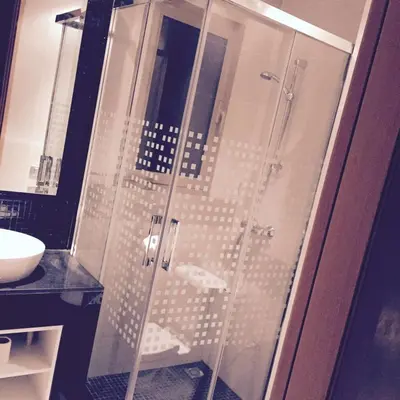 a shower with a glass door in a bathroom at prestigia in Marrakech