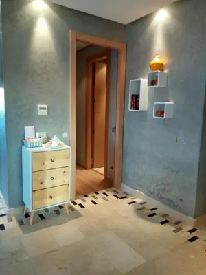 a room with a dresser and a blue wall at prestigia in Marrakech