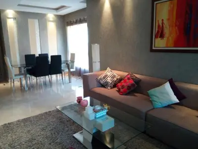 a living room with a couch and a table with chairs at prestigia in Marrakech