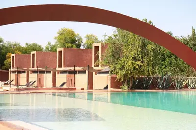 a large swimming pool with a building in the background at Dar Sabra in Marrakech
