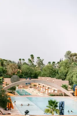 a large swimming pool with a bridge over it at Dar Sabra in Marrakech