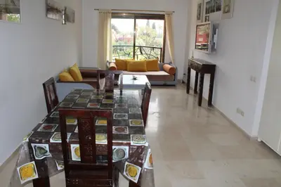 a living room with a table and a couch at La Fontaine in Marrakech