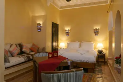a bedroom with a bed and a couch at Riad Omara al Kasbah in Marrakech