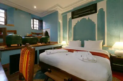 a bedroom with a large bed in a room at Riad Omara al Kasbah in Marrakech