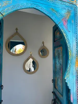 an archway with two mirrors and a blue cabinet at Riad Tsar Mimoun in Marrakech