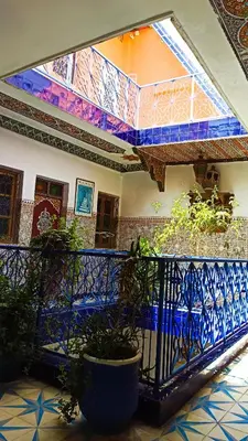 a room with a balcony with plants on it at Hotel Medina in Marrakech