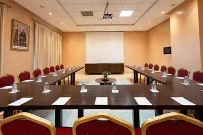 a meeting room with a long table and chairs at Zephyr Targa Marrakech in Marrakech