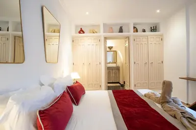 a bedroom with a large white bed with red pillows at Riad Bibazia in Marrakech