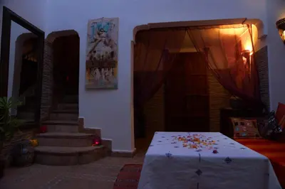 a room with a table with flowers on it at Riad Zehar & Spa Marrakech in Marrakech