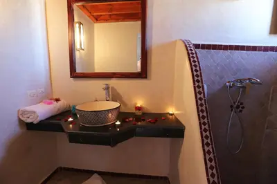 a bathroom with a sink and a shower with a mirror at Riad Zehar & Spa Marrakech in Marrakech