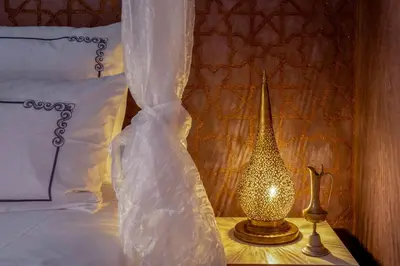 a bedroom with a bed and a lamp on a table at Riad Rêves D'orient & Spa in Marrakech