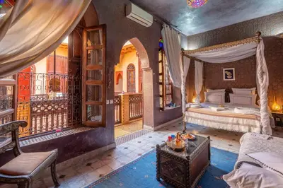 a bedroom with a bed and a balcony at Riad Rêves D'orient & Spa in Marrakech