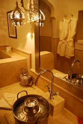 a bathroom with a sink and a mirror and a tub at Riad Viva in Marrakech