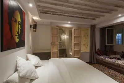 a bedroom with a white bed and a couch at BCK Art Riad in Marrakech