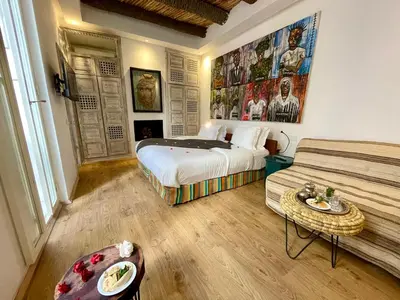 a hotel room with a bed and a couch at BCK Art Riad in Marrakech
