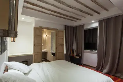 a bedroom with a white bed and a coffered ceiling at BCK Art Riad in Marrakech