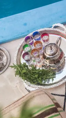 a glass plate with a tea kettle on a table at Riad 46 in Marrakech