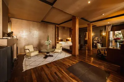 a hotel room with a bed and a living room at Villa Makassar in Marrakech