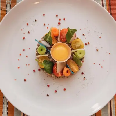 a white plate with a dish of food on it at Villa Makassar in Marrakech