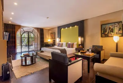 a hotel room with a bed and a living room at Palais Mirage d'Atlas, Hôtel & Spa in Marrakech