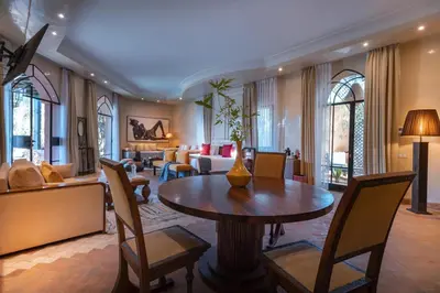 a living room with a table and chairs and a couch at Palais Mirage d'Atlas, Hôtel & Spa in Marrakech