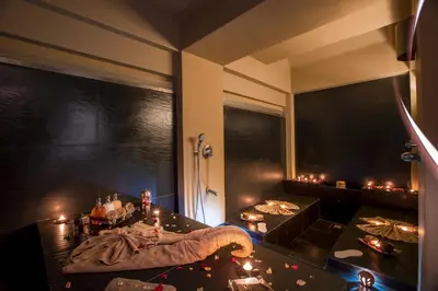 a room with candles on a table and a room with a bed at Palais Mirage d'Atlas, Hôtel & Spa in Marrakech